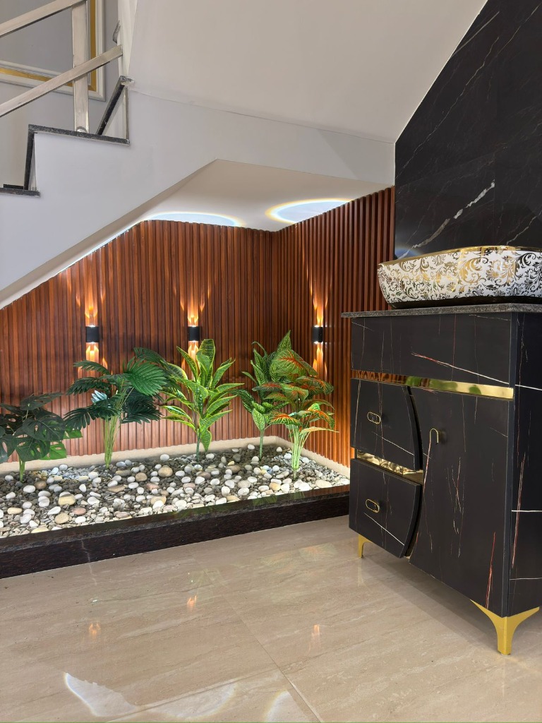Zen-inspired indoor planter area under stairs
